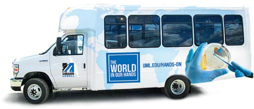A Umass Lowell bus with a complete wrap.